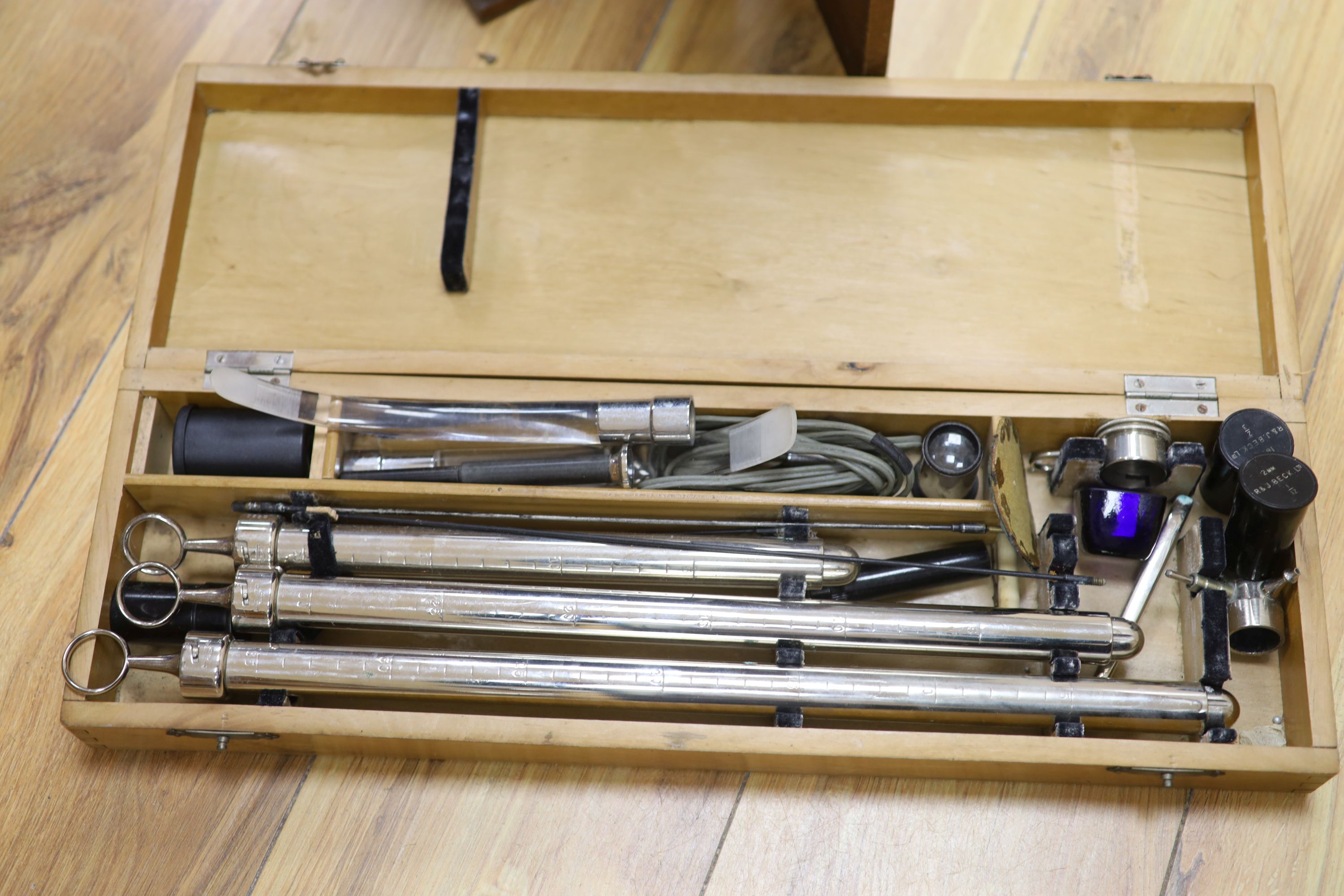 A mahogany cased microscope and veterinary equipment